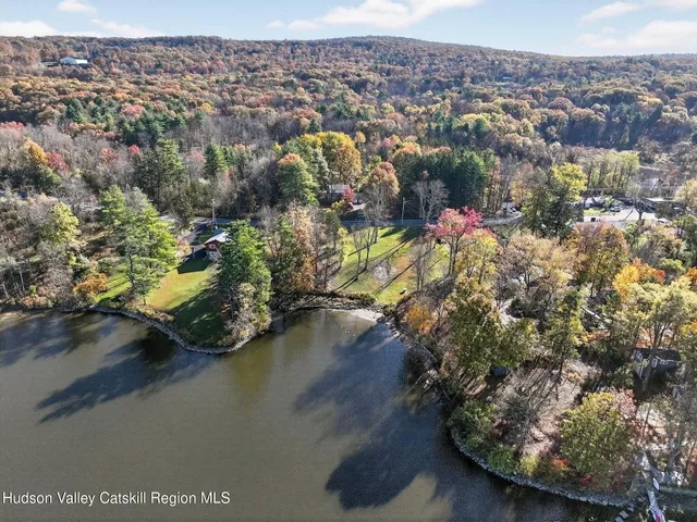 a kitchen with granite countertop a refrigerator a sink and white cabinets
