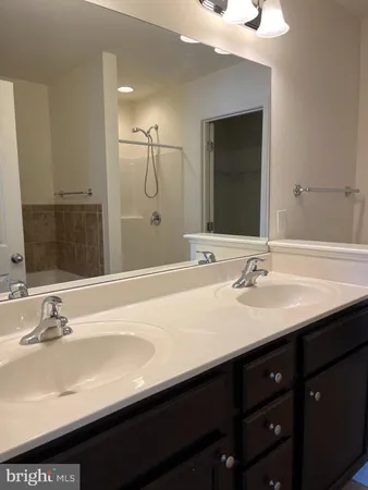 a bathroom with a sink double vanity and a mirror