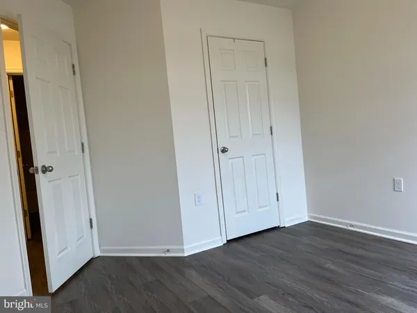 a view of an empty room and wooden floor