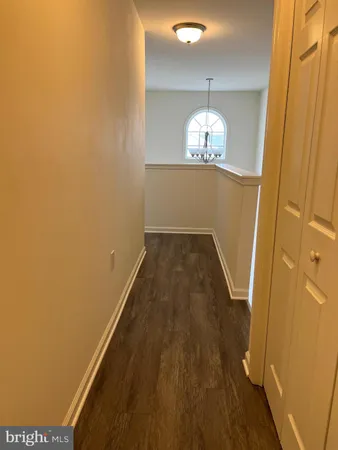 view of a hallway with wooden floor