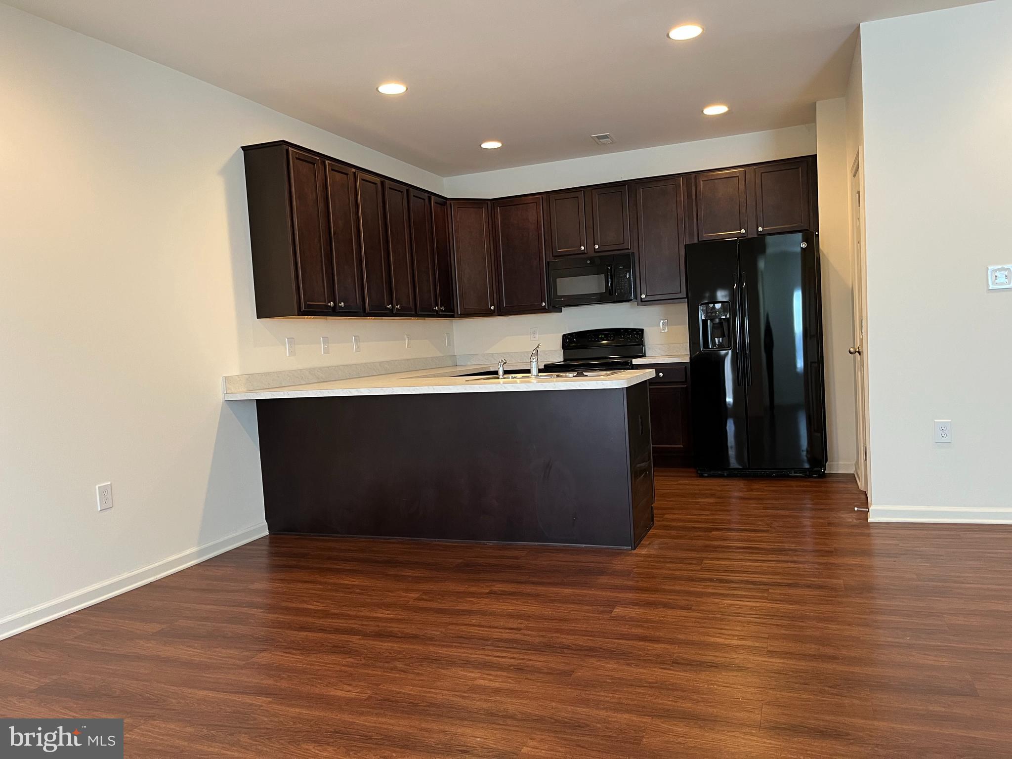 72 Chennault Trail Falling Waters, WV 25419 - Photo 8 of 38 a kitchen with stainless steel appliances wooden cabinets and wooden floor