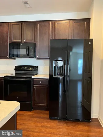 a kitchen with a refrigerator and a stove
