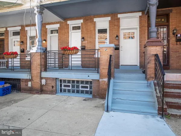 a view of front door of house with stairs