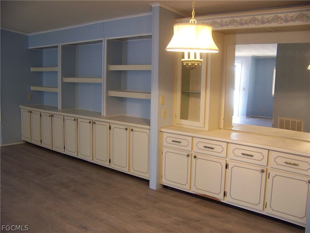 15550 Burnt Store Road, Unit 101 Punta Gorda, FL 33955 - Photo 16 of 50 a view of a kitchen with white cabinets and window