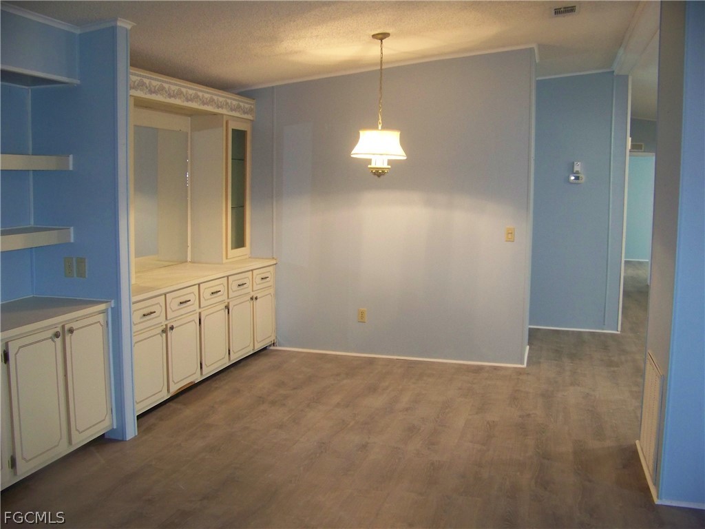 15550 Burnt Store Road, Unit 101 Punta Gorda, FL 33955 - Photo 17 of 50 a view of a hallway with chandelier