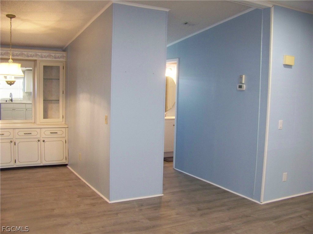 15550 Burnt Store Road, Unit 101 Punta Gorda, FL 33955 - Photo 19 of 50 an empty room with windows and cabinet