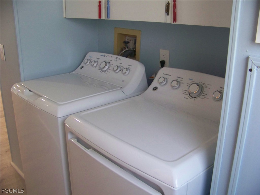 15550 Burnt Store Road, Unit 101 Punta Gorda, FL 33955 - Photo 21 of 50 a utility room with dryer and washer