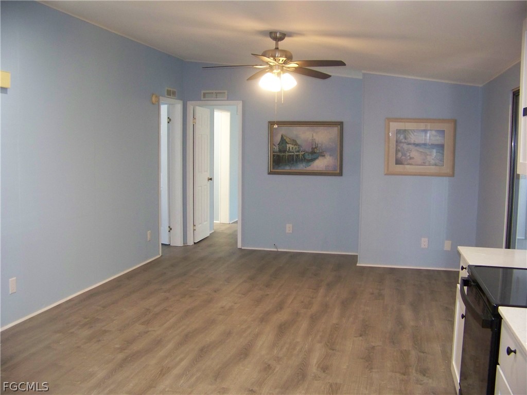 15550 Burnt Store Road, Unit 101 Punta Gorda, FL 33955 - Photo 22 of 50 a view of an empty room with a chandelier fan