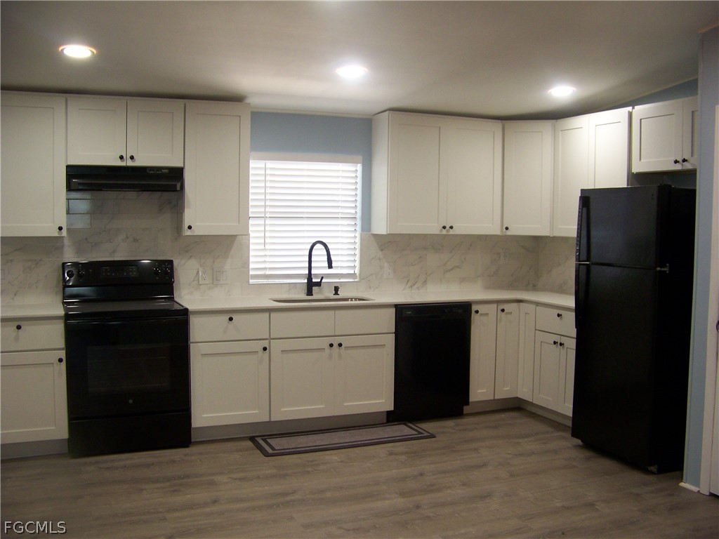 15550 Burnt Store Road, Unit 101 Punta Gorda, FL 33955 - Photo 25 of 50 a kitchen with a refrigerator stove and sink