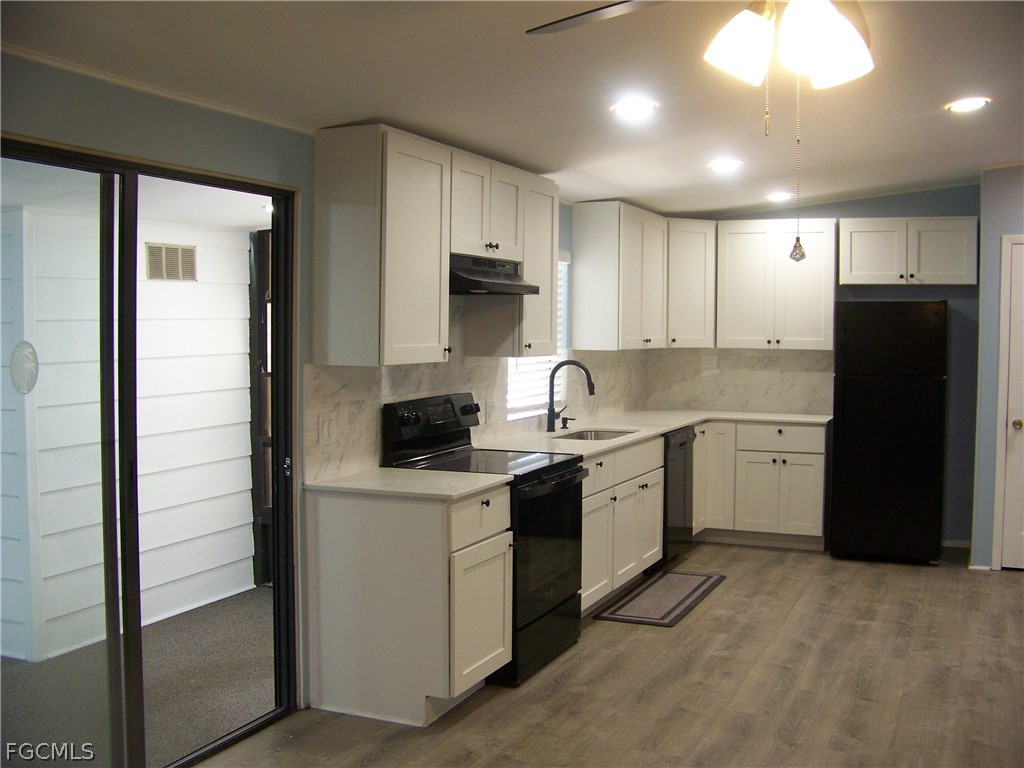 15550 Burnt Store Road, Unit 101 Punta Gorda, FL 33955 - Photo 26 of 50 a kitchen with a sink stove and refrigerator