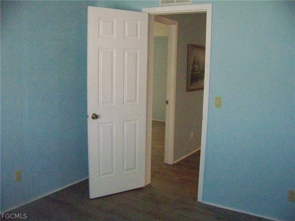 15550 Burnt Store Road, Unit 101 Punta Gorda, FL 33955 - Photo 27 of 50 an empty room with wooden floor