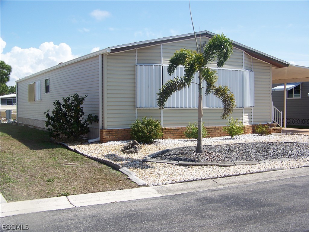 15550 Burnt Store Road, Unit 101 Punta Gorda, FL 33955 - Photo 3 of 50 a palm tree in front of a house