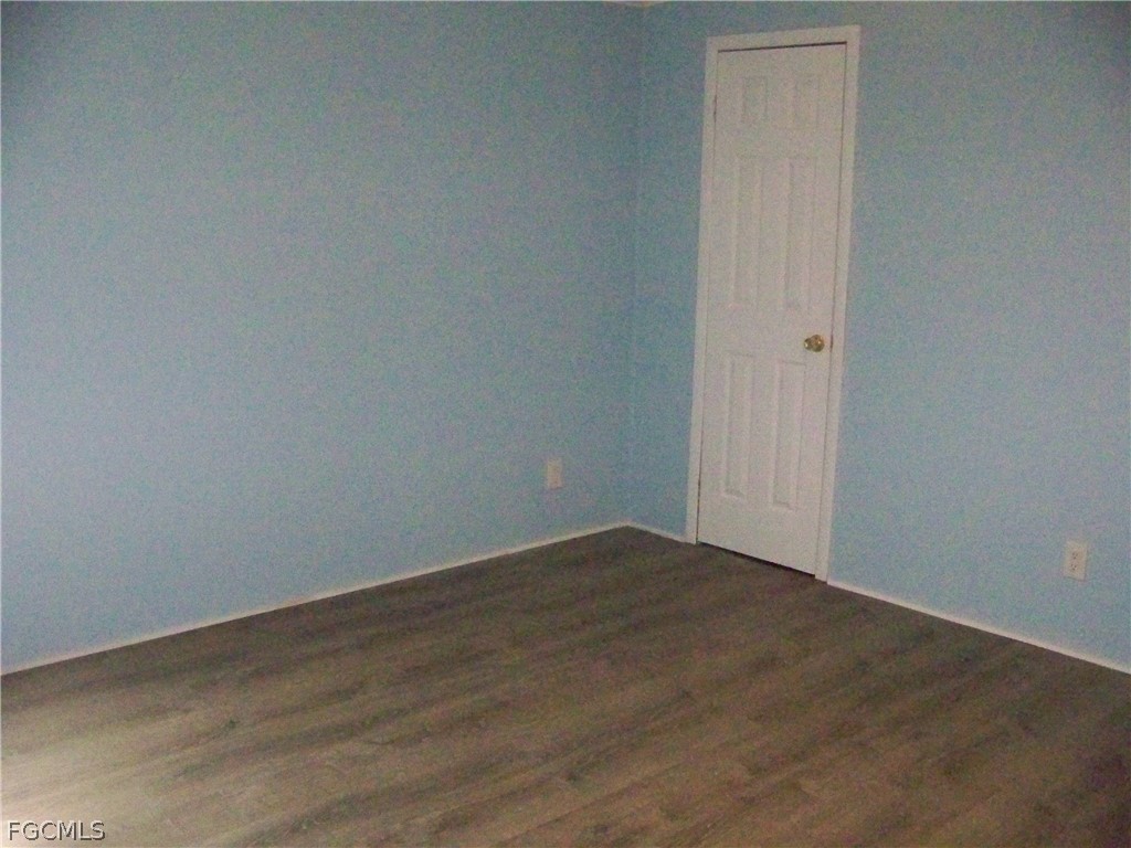 15550 Burnt Store Road, Unit 101 Punta Gorda, FL 33955 - Photo 34 of 50 an empty room with wooden floor