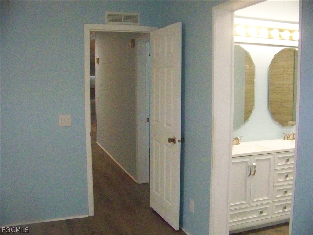 15550 Burnt Store Road, Unit 101 Punta Gorda, FL 33955 - Photo 35 of 50 a bathroom with a sink a mirror and a shower