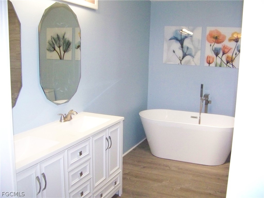 15550 Burnt Store Road, Unit 101 Punta Gorda, FL 33955 - Photo 36 of 50 a bathroom with a sink and a mirror