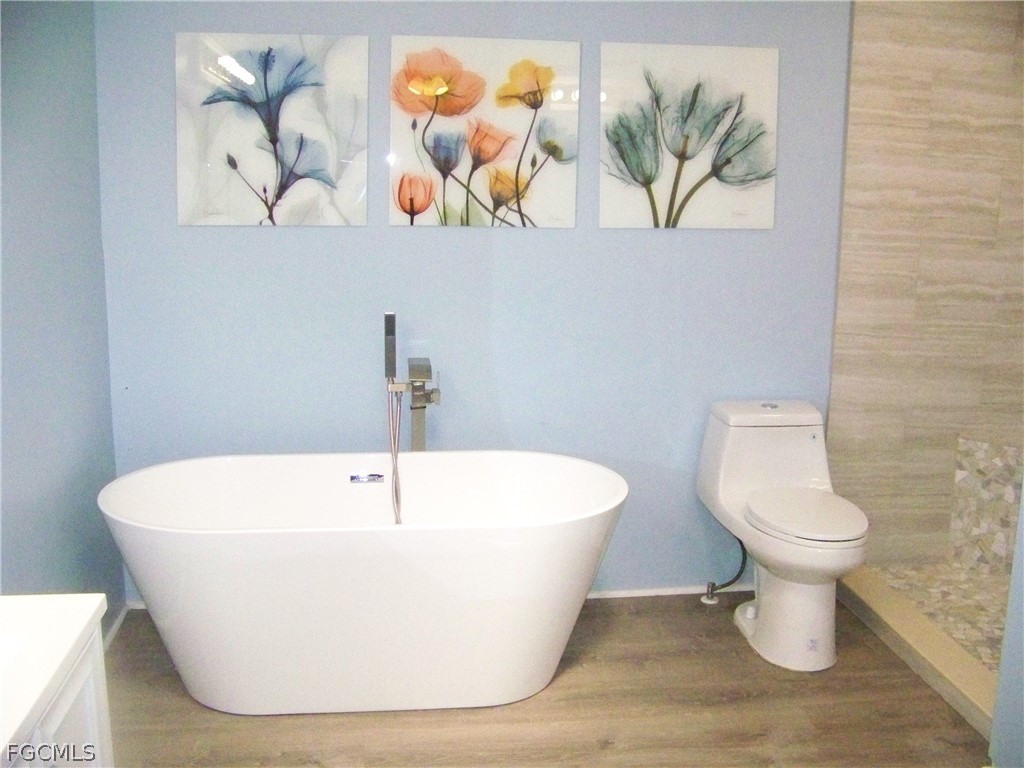 15550 Burnt Store Road, Unit 101 Punta Gorda, FL 33955 - Photo 37 of 50 a white bath tub sitting in a bathroom