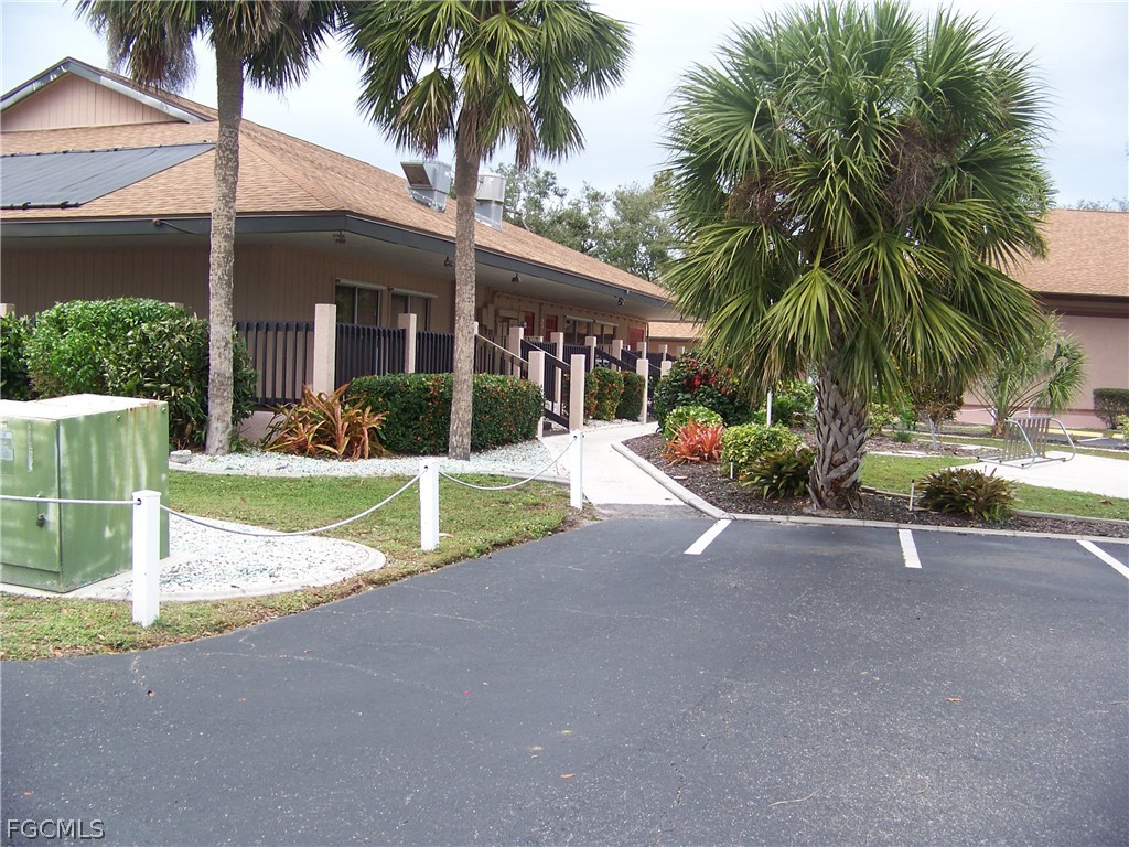 15550 Burnt Store Road, Unit 101 Punta Gorda, FL 33955 - Photo 47 of 50 a view of a house with a yard and palm trees