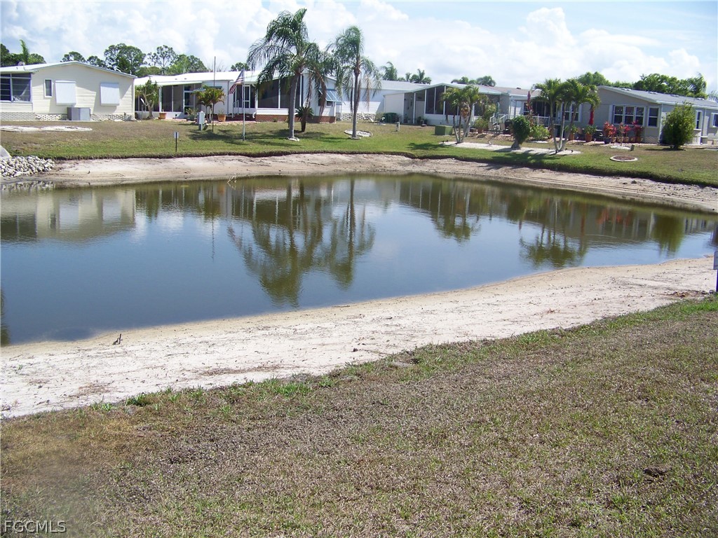 15550 Burnt Store Road, Unit 101 Punta Gorda, FL 33955 - Photo 6 of 50 a view of a lake with a building in the background