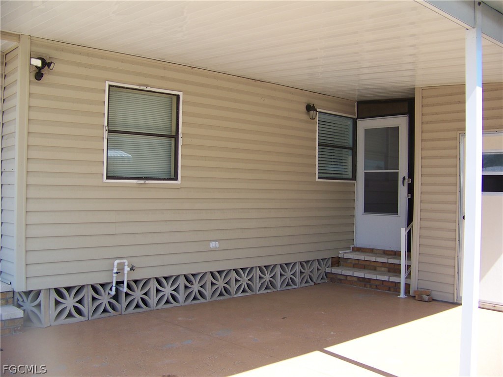15550 Burnt Store Road, Unit 101 Punta Gorda, FL 33955 - Photo 10 of 50 a view of a house with a wooden fence