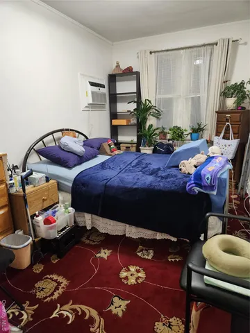 a bedroom with a bed and dresser