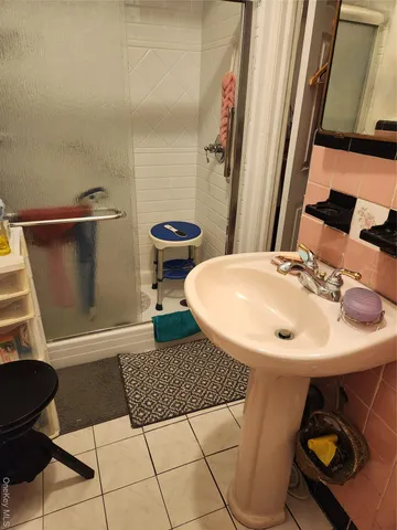 a bathroom with a sink toilet and mirror