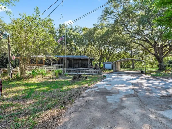 a view of house with backyard