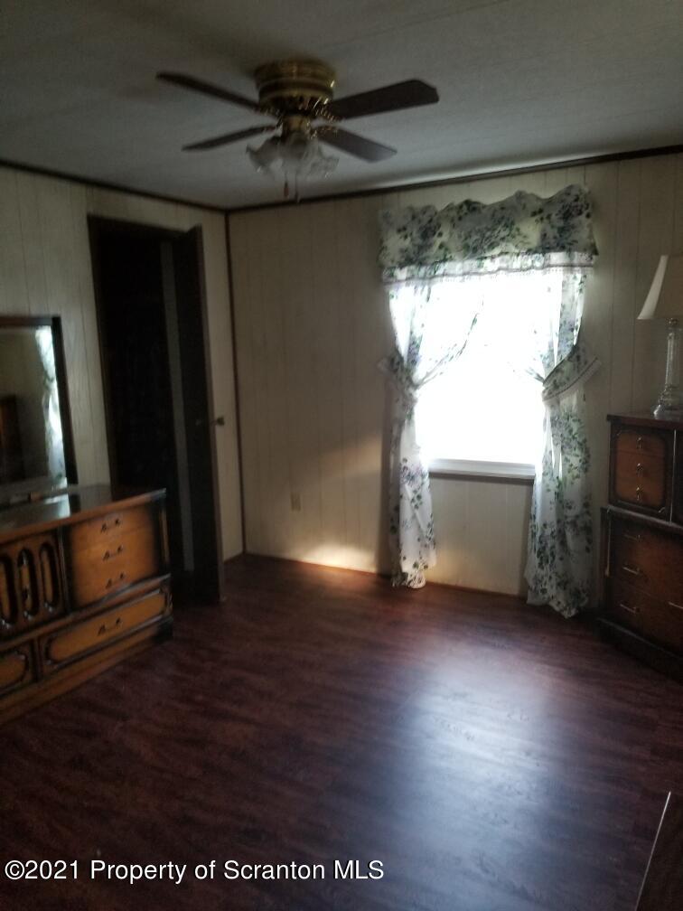 337 Main Street Forest City, PA 18421 - Photo 3 of 6 a view of a livingroom with wooden floor and a fireplace