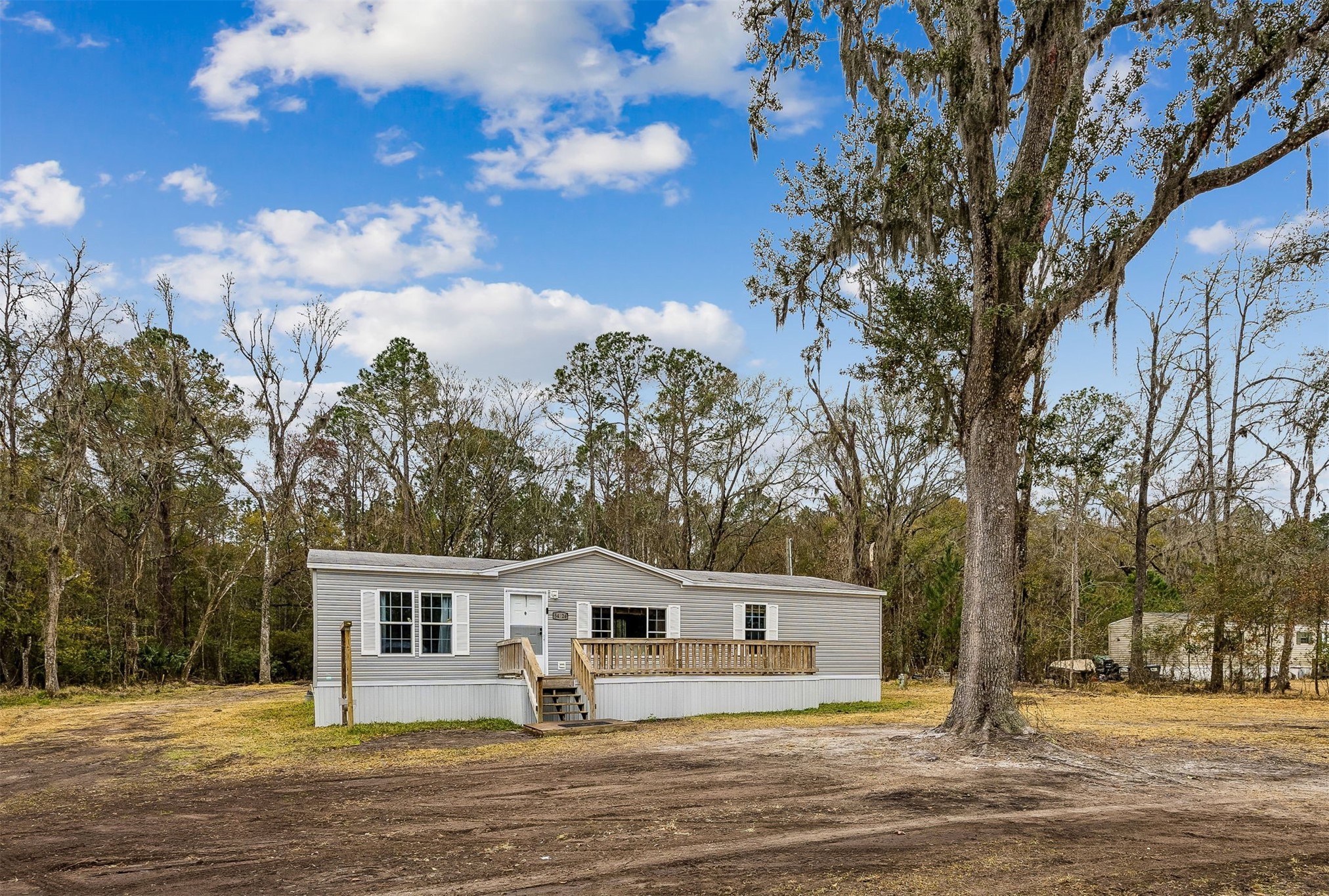 54124 Catherine Avenue Callahan, FL 32011 - Photo 1 of 29 a front view of a house with a yard and trees