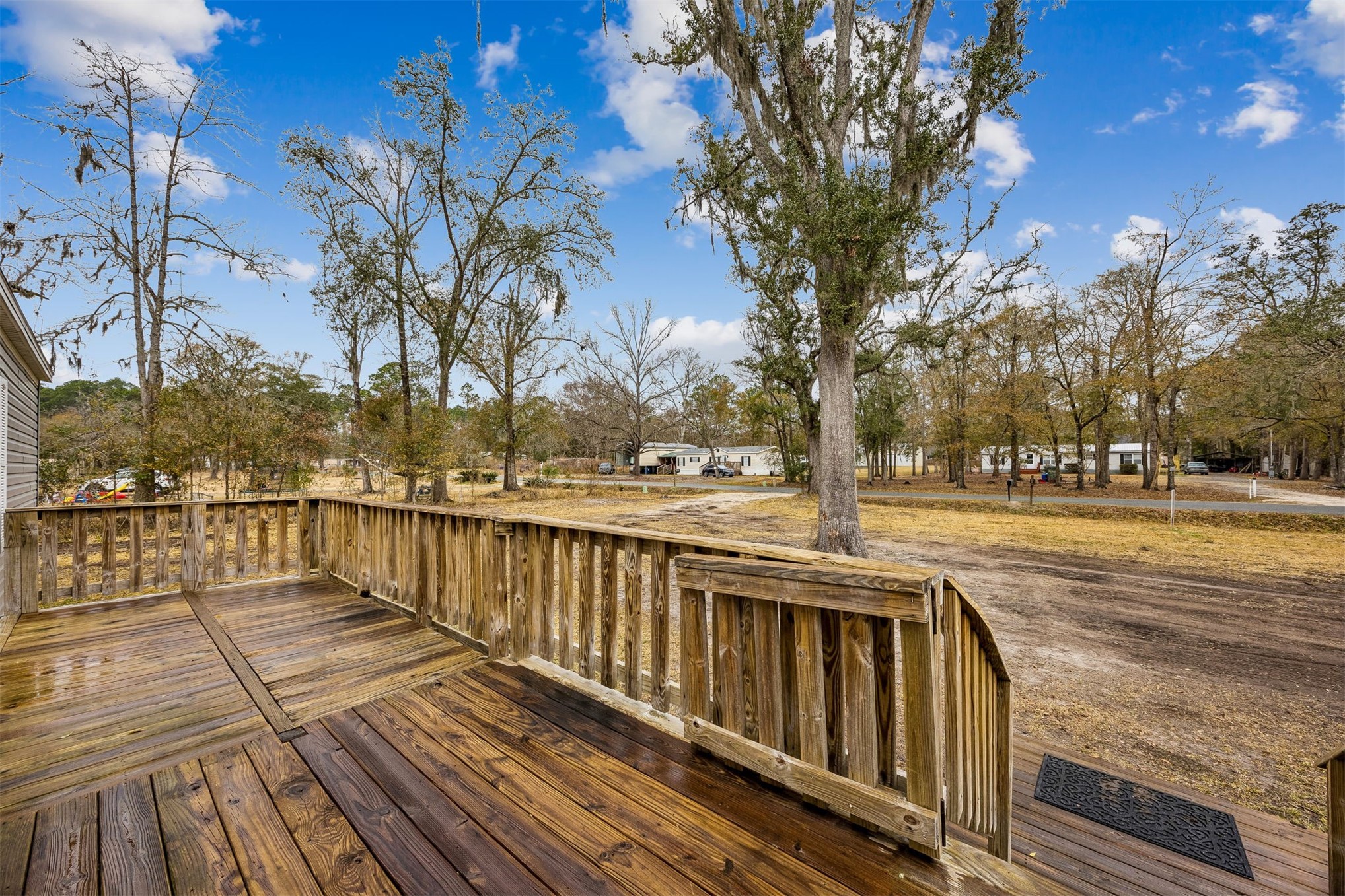 54124 Catherine Avenue Callahan, FL 32011 - Photo 18 of 29 a view of balcony with wooden floor and trees