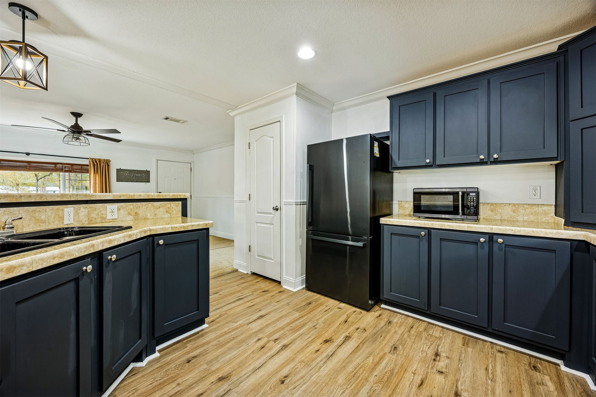 54124 Catherine Avenue Callahan, FL 32011 - Photo 21 of 29 a kitchen with a refrigerator sink and wooden cabinets