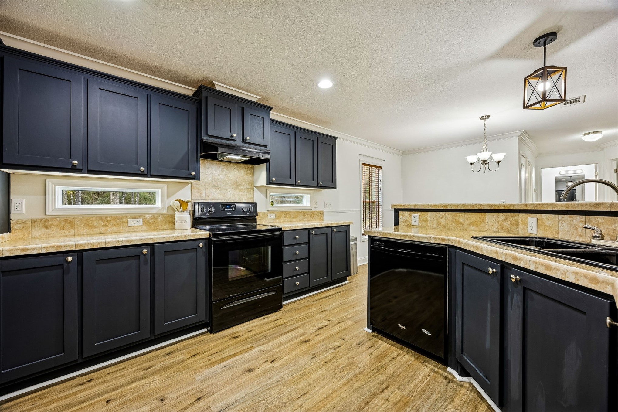54124 Catherine Avenue Callahan, FL 32011 - Photo 3 of 29 a kitchen with granite countertop wooden cabinets and black stainless steel appliances