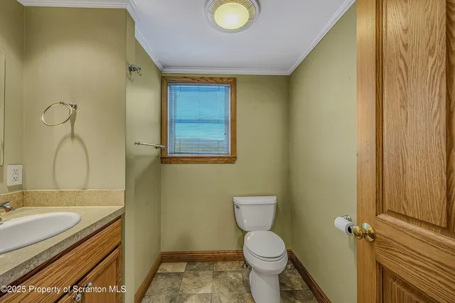 a bathroom with a granite countertop toilet and a sink