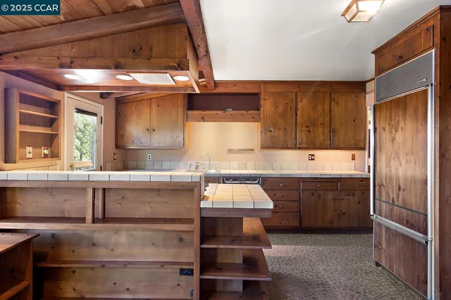 a kitchen with kitchen island granite countertop a sink and a stove
