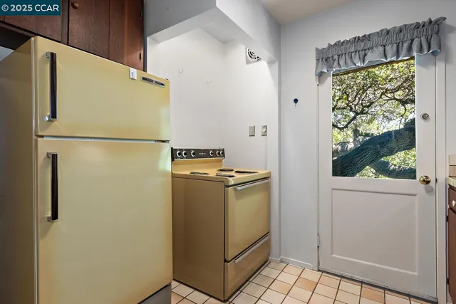 a white refrigerator freezer and a stove sitting inside of a kitchen
