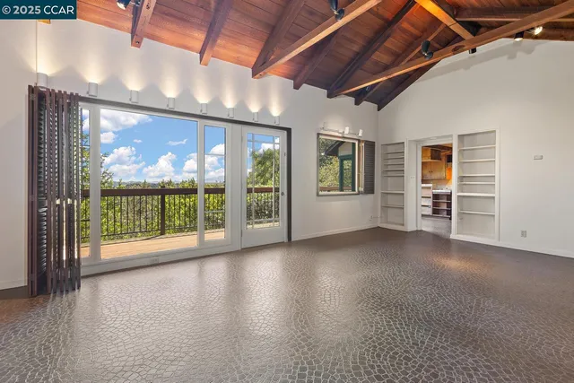 a view of a room with wooden floor and balcony