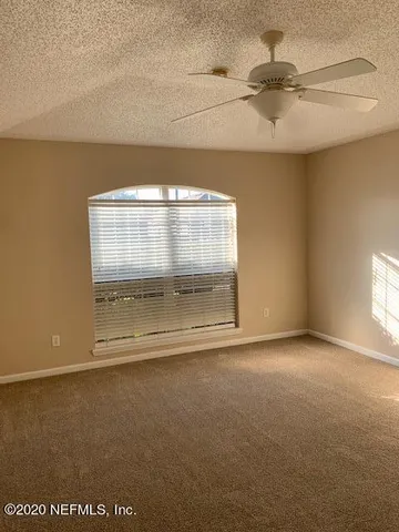 an empty room with a empty space and windows