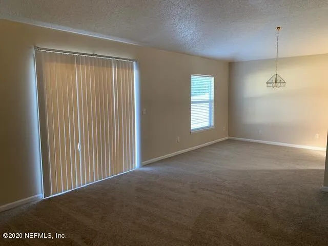 a view of empty room with windows