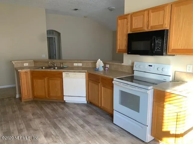 a kitchen with a stove and a microwave
