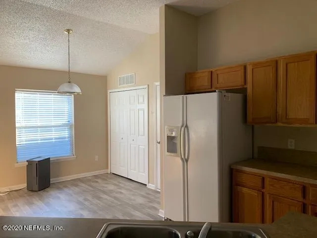 a kitchen with stainless steel appliances a refrigerator and a stove