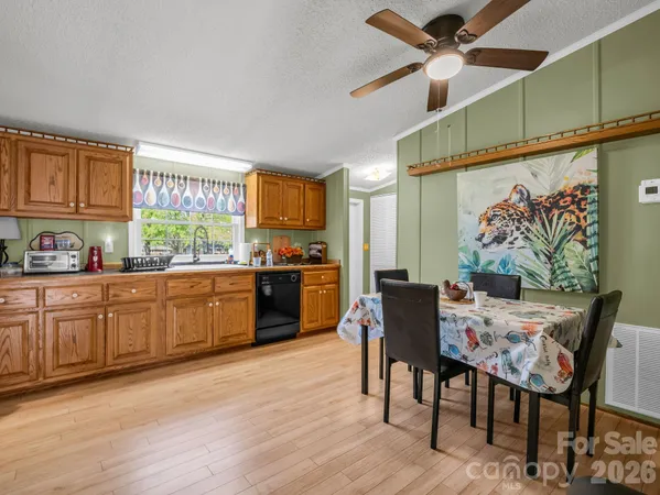 a kitchen with a table chairs refrigerator and cabinets