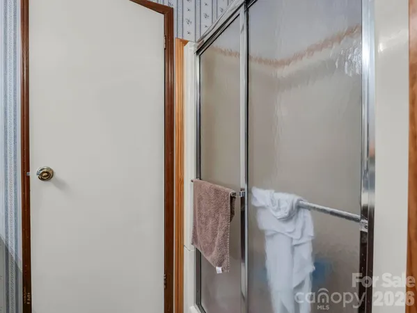 a bathroom with a glass shower door