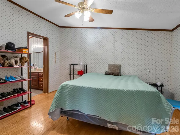 a bedroom with a bed and a chandelier