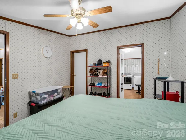 a bedroom with a bed and a chandelier