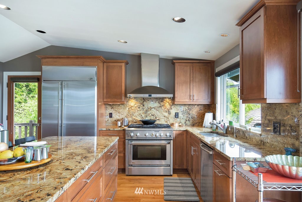 4044 East Mercer Way Mercer Island, WA 98040 - Photo 11 of 37 a kitchen with stainless steel appliances granite countertop a stove a sink and a refrigerator