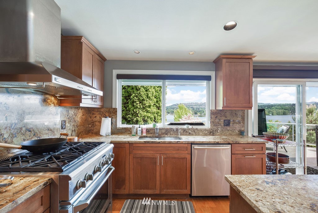 4044 East Mercer Way Mercer Island, WA 98040 - Photo 12 of 37 a kitchen with stainless steel appliances granite countertop a stove a sink and a microwave