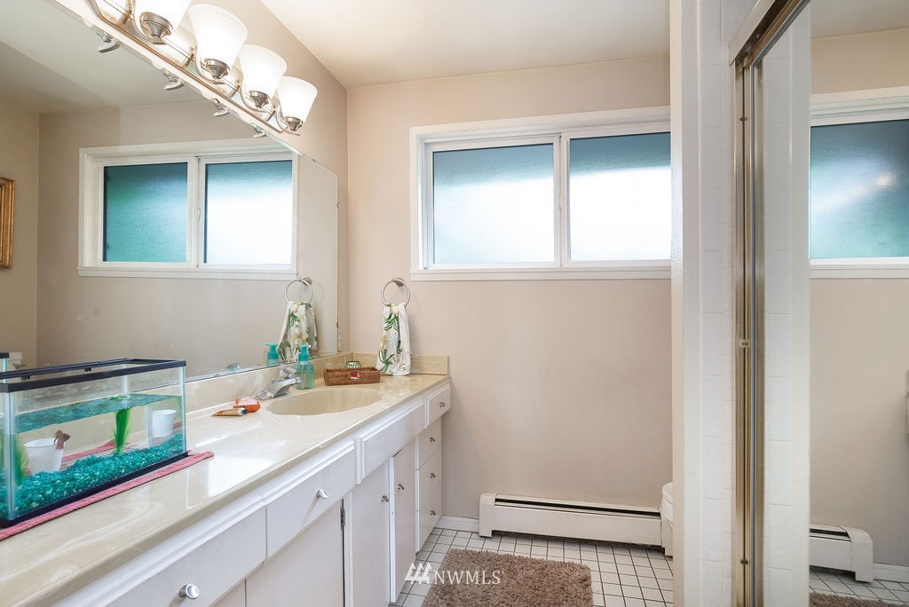 4044 East Mercer Way Mercer Island, WA 98040 - Photo 15 of 37 a bathroom with a sink a vanity and a mirror