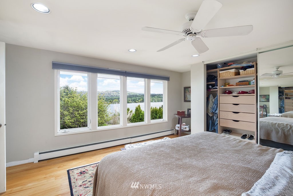 4044 East Mercer Way Mercer Island, WA 98040 - Photo 17 of 37 a bedroom with a large bed and a large window