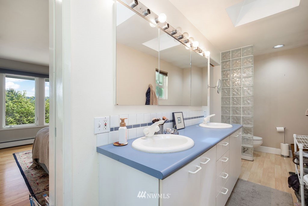 4044 East Mercer Way Mercer Island, WA 98040 - Photo 18 of 37 a bathroom with a sink double vanity and a toilet