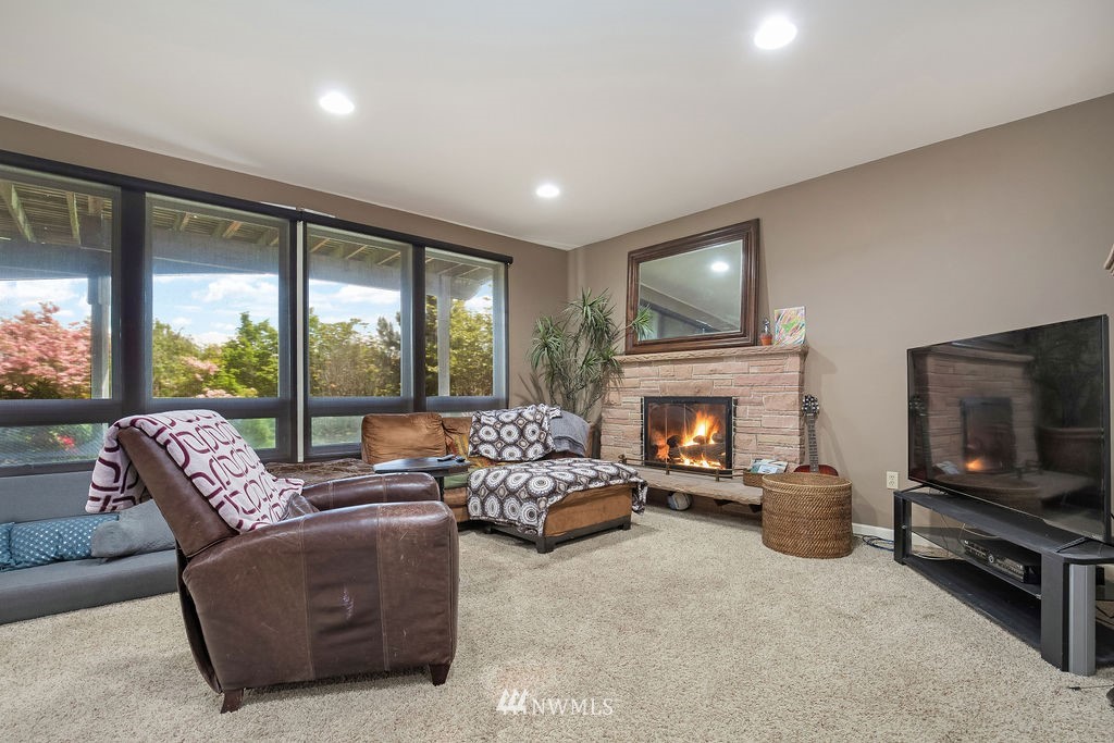 4044 East Mercer Way Mercer Island, WA 98040 - Photo 21 of 37 a living room with furniture a flat screen tv and a fireplace