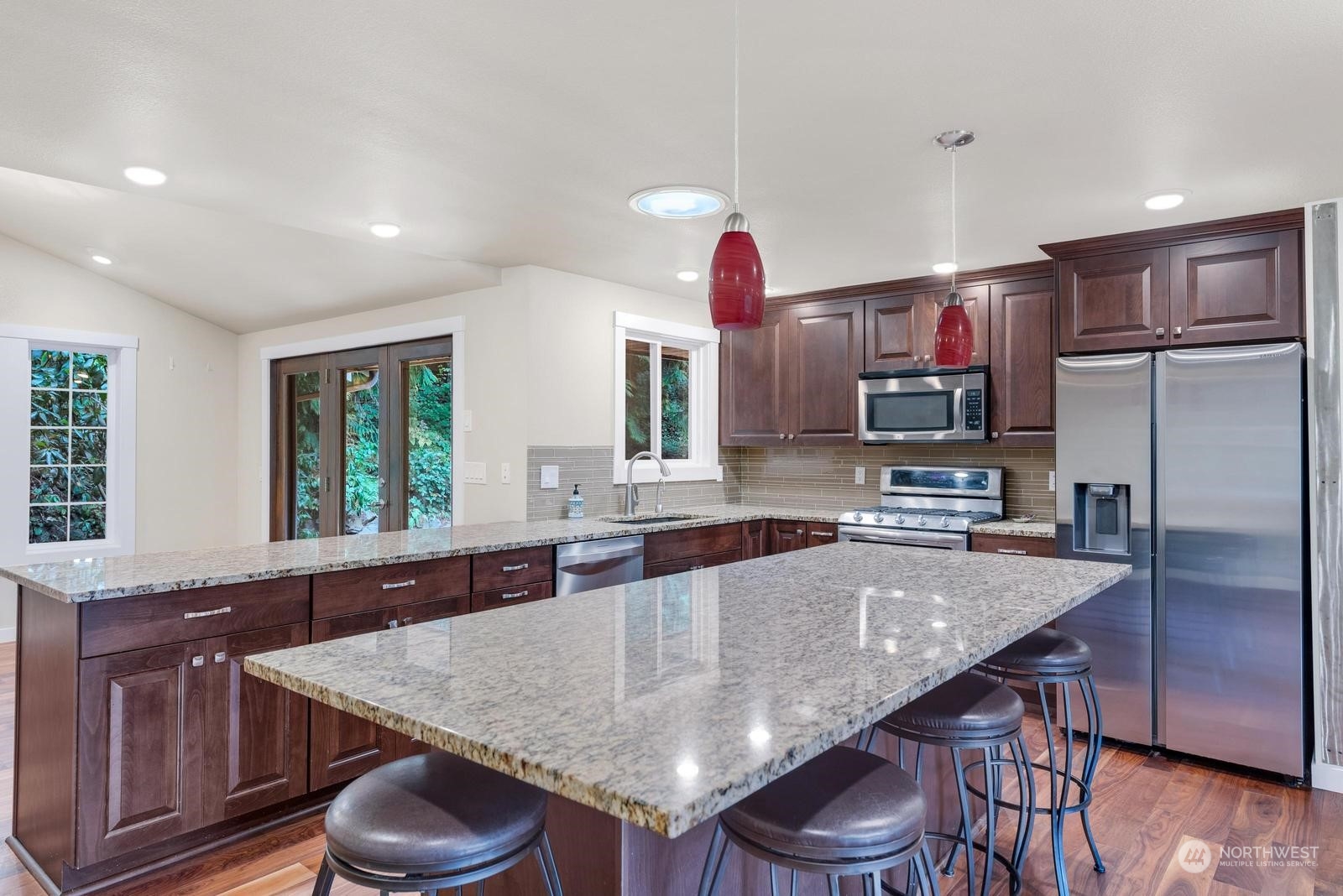 23002 2nd Avenue Southeast Bothell, WA 98021 - Photo 8 of 22 a kitchen with granite countertop stainless steel appliances a sink and a refrigerator